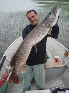 Man posing with a pike