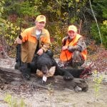 2 hunters with a bear